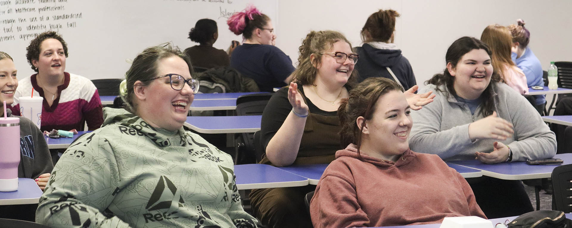 Students smile while in a leadership class.
